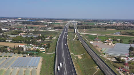 Aerial-view-of-the-highway-with-no-traffic-sunny-day-train-station-sud-de-France